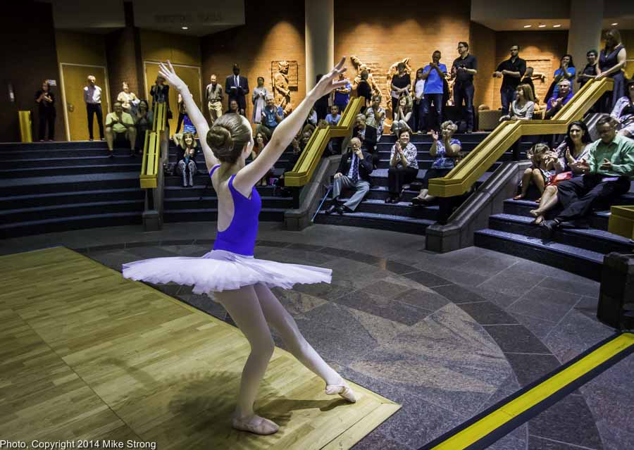 Young dancer with Cresendo Academy in an exhibition in the lobby of JCCC's Carlsen Center as a pre-show before New Dance Partners in theater behind them